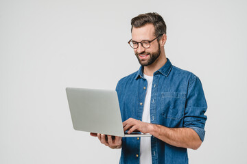 Successful caucasian young man student freelancer using laptop, watching webinars, working remotely, e-learning e-commerce online isolated in white background