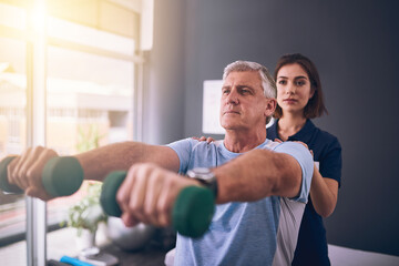 Aufkleber - You gotta keep your strength up. Cropped shot of a young female physiotherapist treating a mature male patient.