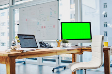 Ready to start working. Shot of an unoccupied desk with a computer and digital tablet on it inside of a office during the day.