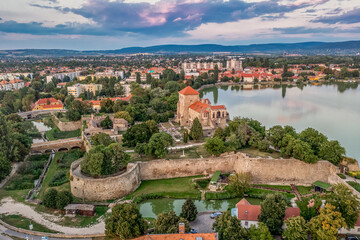 Poster - Aerial sunset view over the old lake of Tata with medieval castle surrounded by moat, bastions and walls in Hungary