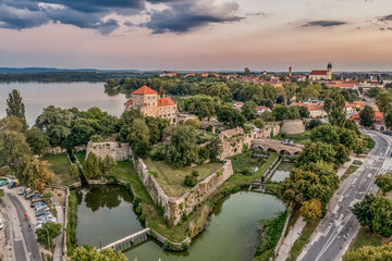 Wall Mural - Aerial sunset view over the old lake of Tata with medieval castle surrounded by moat, bastions and walls in Hungary