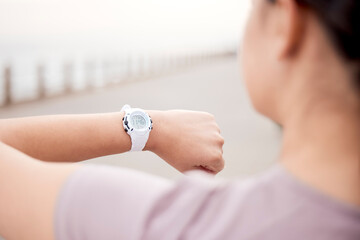 Canvas Print - Time is precious, use it smartly. Shot of an unrecognisable woman using a smart watch during her run on the promenade.