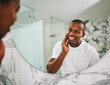 © Lyndon Stratford/peopleimages.com - Hey there handsome. Shot of a young man going through his morning routine in the bathroom at home.