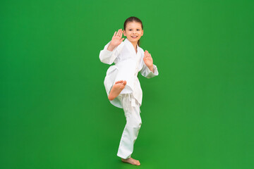 Wall Mural - A child in a white kimono, karate for child development.