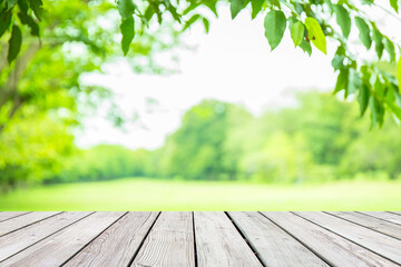 Wall Mural - Empty wooden table with garden bokeh for a catering or food background with a country outdoor theme,Template mock up for display of product