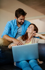 Canvas Print - Dont forget to tag me in that.... Cropped shot of an affectionate young couple relaxing on the sofa at home.