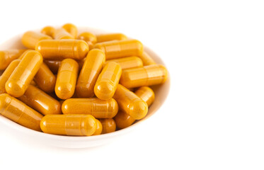 Wall Mural - Ground Turmeric in Capsule form on a White Background