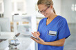 © Yuri Arcurs/peopleimages.com - Support for a surgeon. A beautiful female doctor holding a tablet while standing in a lab.