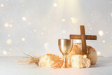 Fototapeta  - Chalice of wine with bread and cross on light background. Holy Communion concept