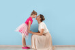 © Pixel-Shot - Portrait of happy mother and daughter on color background
