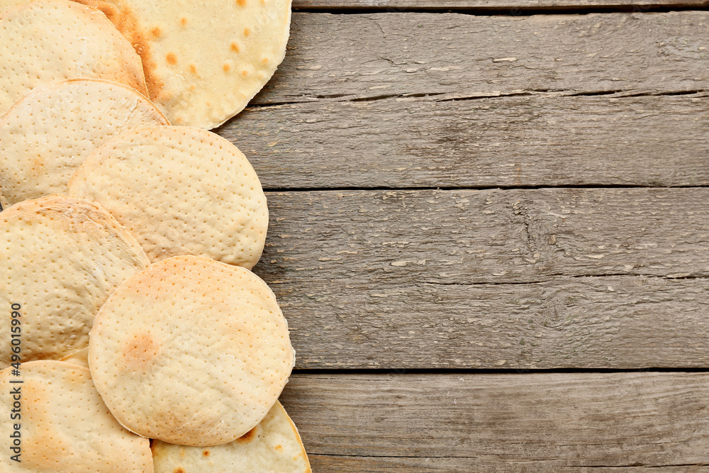 Round Jewish flatbread matza for Passover on wooden background