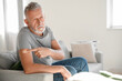 Mature man with applied nicotine patch at home. Smoking cessation