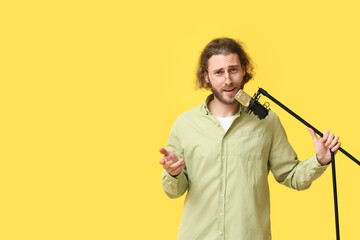 Sticker - Handsome young man singing in microphone on yellow background