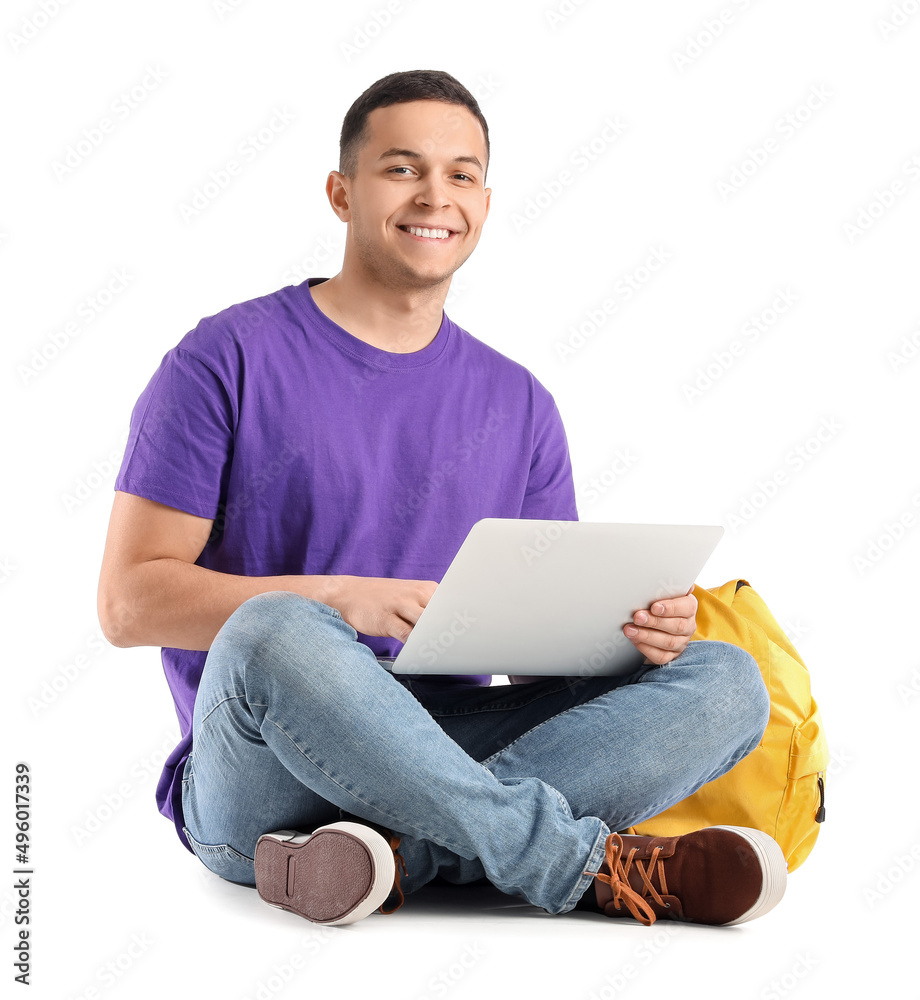 Male student using laptop on white background