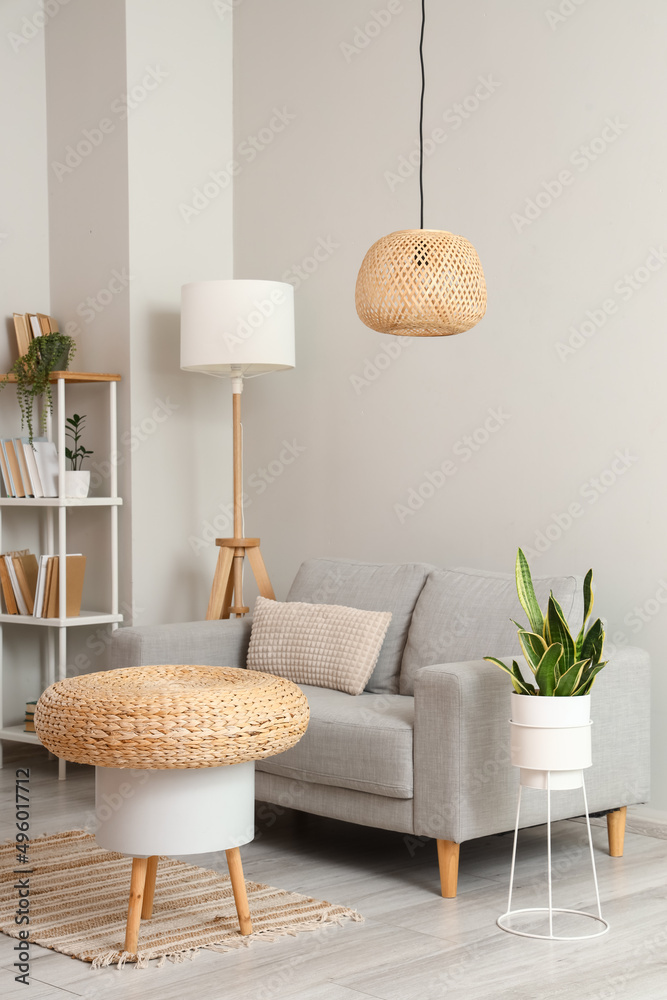 Wicker table in stylish room interior