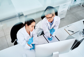 Poster - Science is about expanding the whole world. Shot of two scientists working together on a computer in a lab.