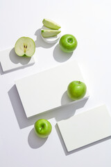 Wall Mural - Top view of green apple with white podium and blank space for advertising 