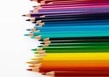 A Row Of Colorful Pencils On White Background