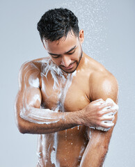 Poster - Lather up and scrub. Studio shot of a handsome young man taking a shower against a grey background.