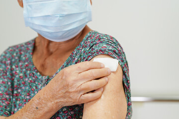 Wall Mural - Asian elder senior woman with protective face mask getting vaccine for protect corona virus.