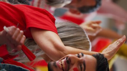 Wall Mural - Excited senior woman and young man football fans supproting English national team in live soccer match at stadium.