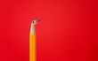 Broken pencil tip on red background