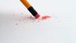 Pencil eraser erasing on white background