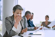 Being sick is keeping me out of the discussion. Cropped shot of a sick businesswoman blowing her nose in the boardroom.