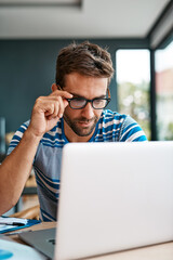 Poster - Getting into the details. Cropped shot of a handsome young male entrepreneur working from his home office.