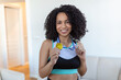 © Graphicroyalty - Portrait of an attractive young female athlete posing with her gold medal. African American Athlete showing first place medal