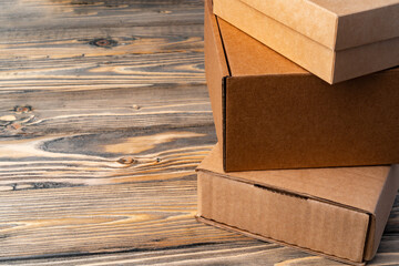 Wall Mural - Pile of cardboard boxes on wooden background