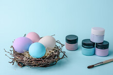 Easter Nest Egg With Colorful Eggs Easter Eggs Paints To Paint Hande Made And Brush On Blue Decoration.
