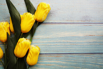 Sticker - Yellow tulip flower bouquet with space copy on wooden background