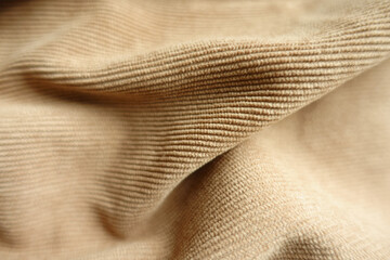 Wall Mural - Close shot of light brown corduroy fabric in soft folds