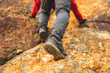Close up leg Climber man hiking on rocky mountains at vacations time. Young traveler man mountaineering on adventure trip at holidays. Travel lifestyle concept.
