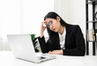 © Chanakon - Young asian business woman hand touching head she's feeling depressed stress headache be tired from working with laptop a long time she symptom office syndrome.