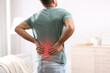© New Africa - Man suffering from back pain at home. Bad posture problem