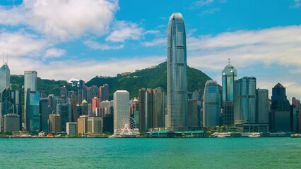 Poster - Hong Kong. Skyline of Hong Kong during the day. Beautiful skyscrapers with colorful cloudy sky. Time-lapse with boats, panning video