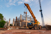 A Mobile Crane And Tower Crane For Pouring Concrete In Construction Site.