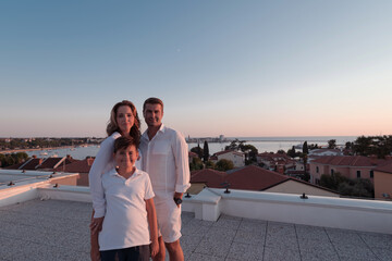 Wall Mural - Happy family enjoys and spends time together on the roof of the house. Selective focus 