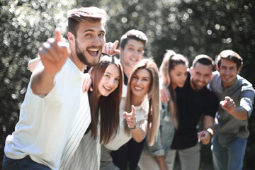 group a team of young people pointing at you