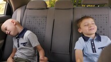 Two Little Brothers Of Eight Years Old Are Having Fun Sitting In The Back Seat Of A Car, They Dance To The Music And Laugh.
