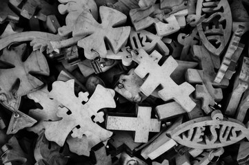 Different wooden crosses and Jesus fish symbol for sale at market in Old City of Jerusalem, Israel. Black white historic photo.