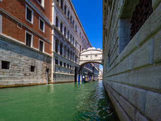 Wall Mural - Typical canal of Venice with gondoliers