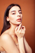 © iordani - cute happy young indian woman in studio closeup smiling on brown background, fashion beauty lifestyle people concept