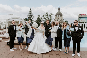 Wall Mural - Stylish groom and bride with their friends