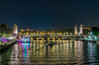 Paris Center at Night with Boats Traffic Over Seine River Bridges and Docks