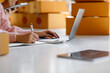 © David - Portrait of Starting small businesses SME owners, two Asian woman check online orders Selling products working with boxs freelance work at home office, sme business online small medium enterprise