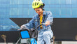 © ADDICTIVE STOCK - Smiling ethnic woman in helmet riding bicycle on city