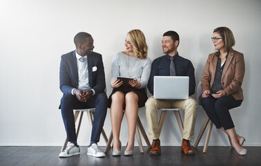 Poster - Waiting can be strenuous, start conversations. Studio shot of businesspeople waiting in line against a white background.